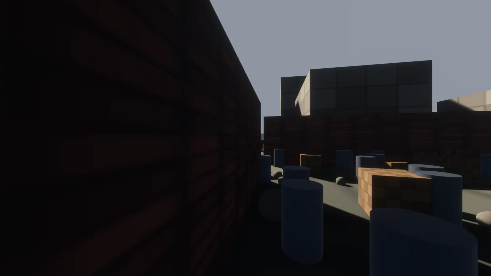 Walking pose in the test city with the defaults on: a brick yard wall, a building and props at close range, all at full detail